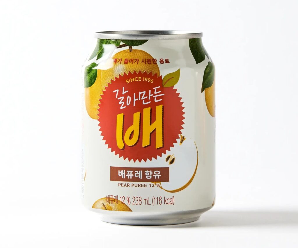 A bottle of Korean Pear Drink on a table with a white and gray floral pattern.