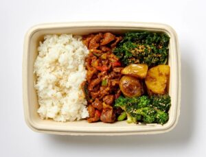 Korean spicy pork plate with rice, soy-roasted potatoes, and garlic broccoli at Sopo Korean Eats Midtown NYC.