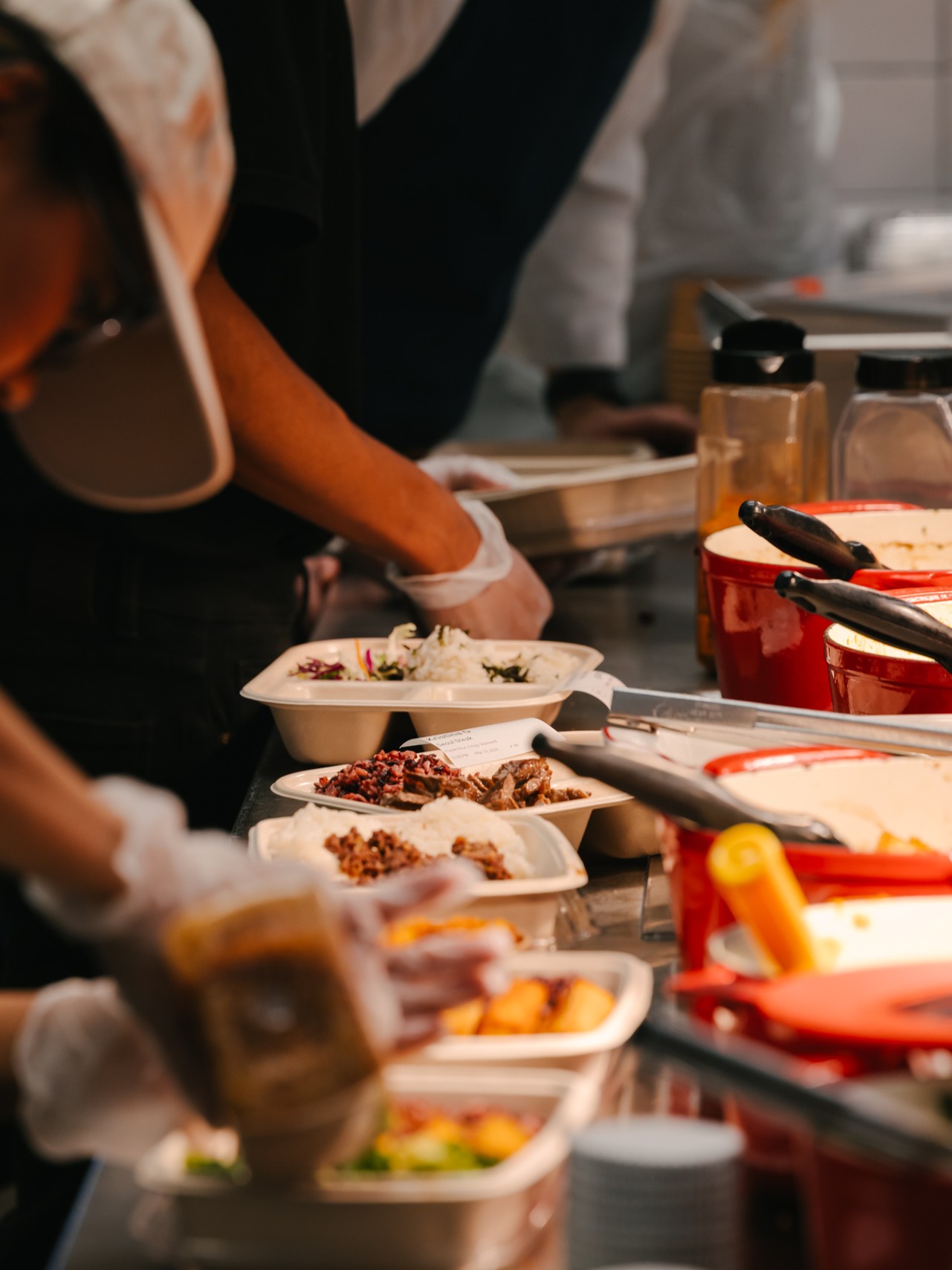 Sopo Korean Eats plates with bulgogi, spicy pork, sides, and rice on a table in Midtown NYC.