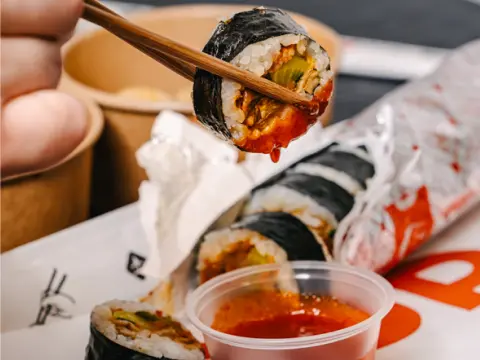 Variety of freshly rolled Korean kimbap for catering from Sopo Korean Eats