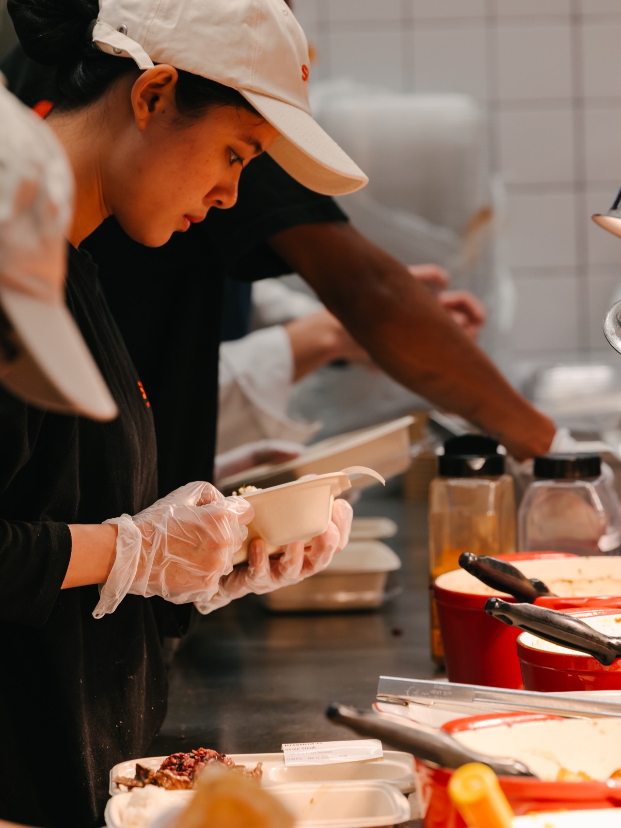 A chef at Sopo Korean Eats, preparing our signature Korean plate in Midtown, NYC.