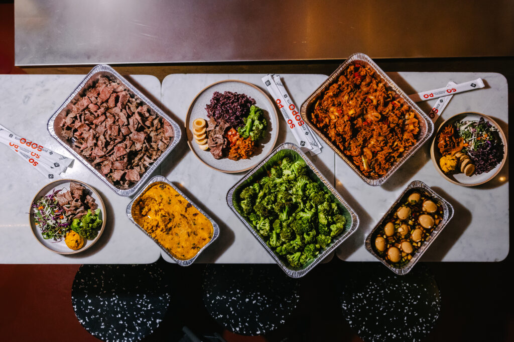 Build-your-own Korean plate with purple rice, beef bulgogi, kimchi, and house sauce at Sopo Korean Eats
